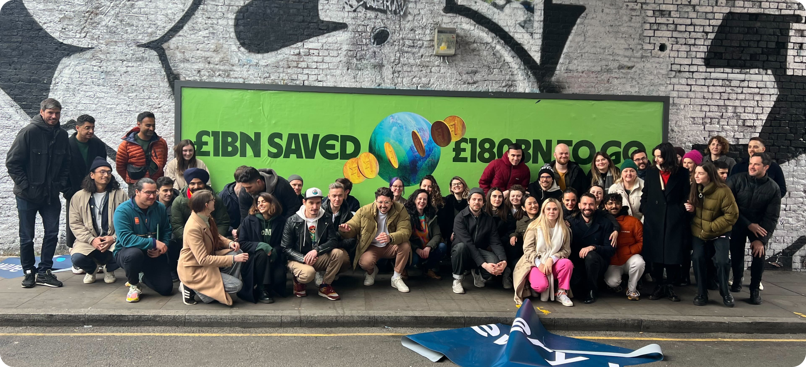 The team in front of the rebranded billboard in Shoreditch, London